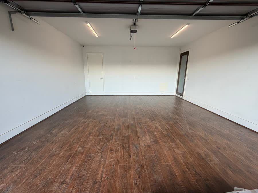 Completed dark walnut-look flooring in a Melbourne garage conversion